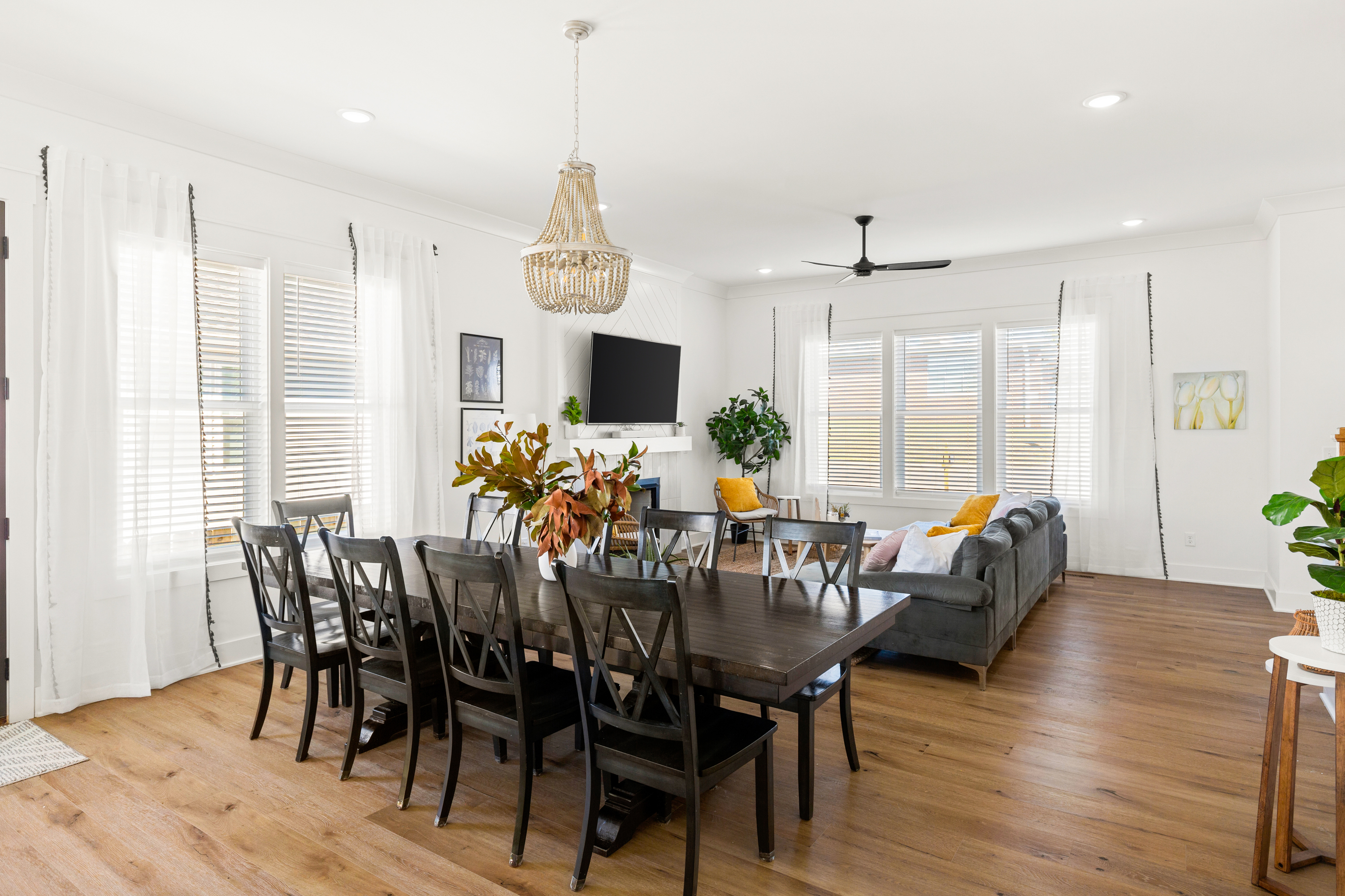 Dining area with a large wooden table and elegant chandelier